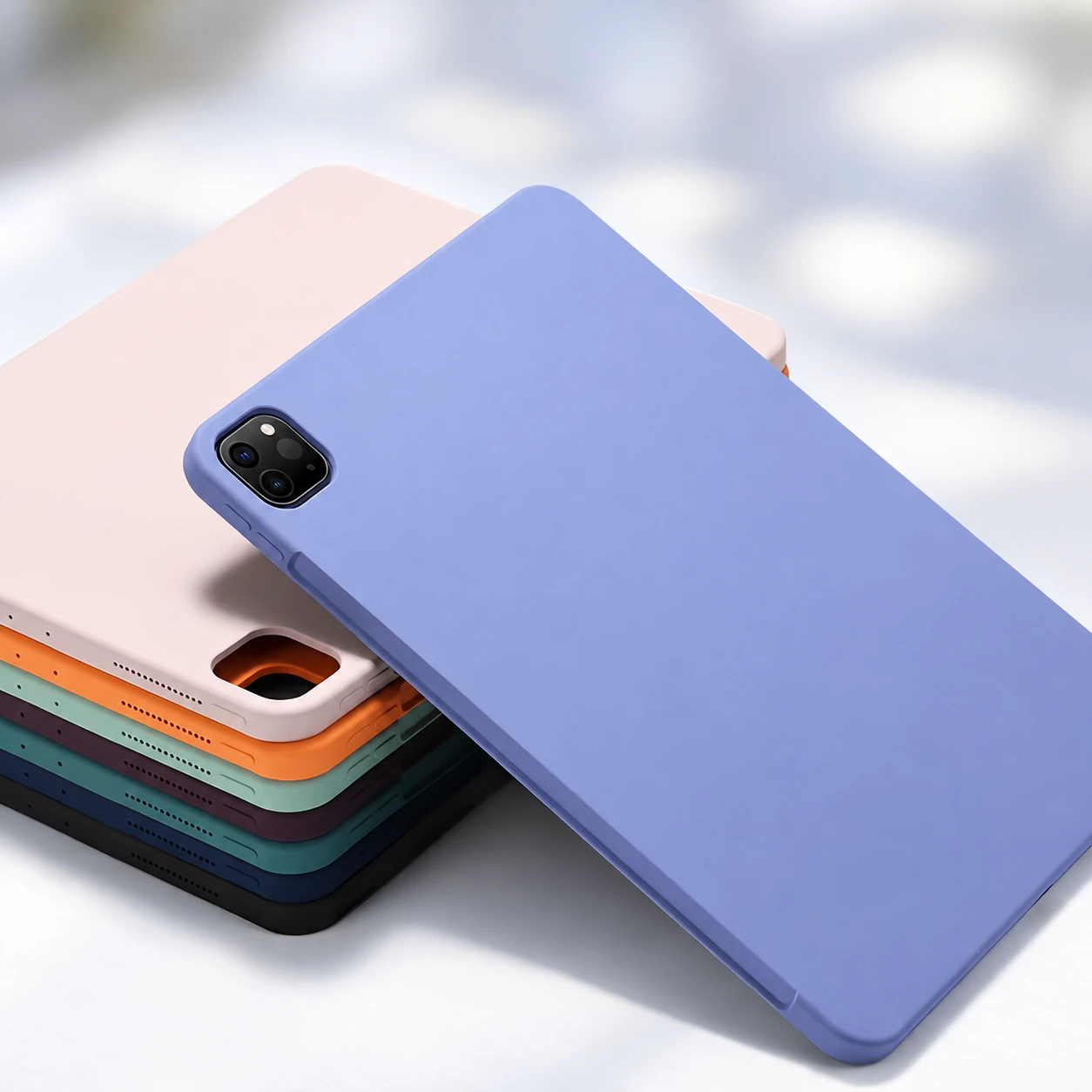 Lavender silicone tablet case with stacked multicolor tablet covers