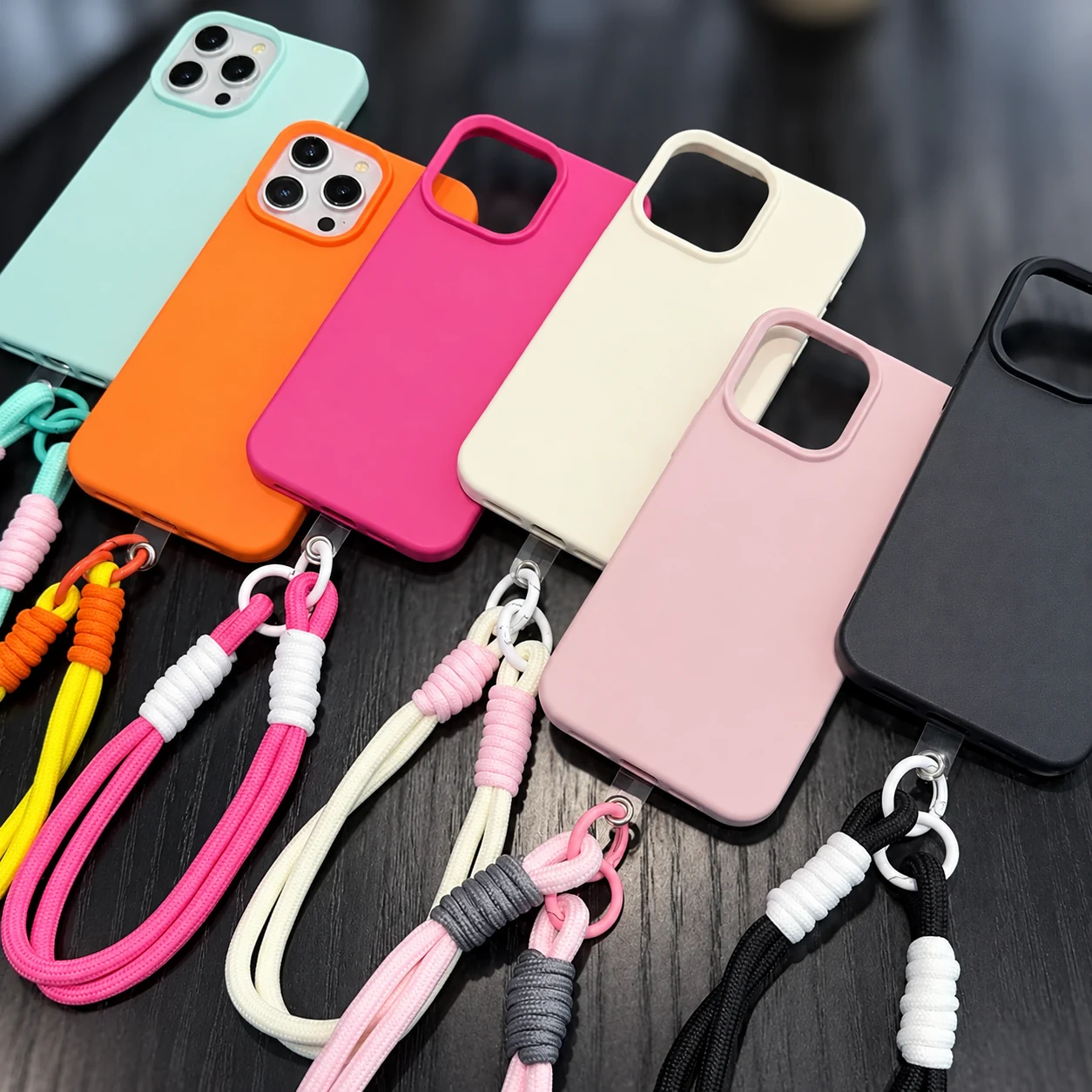 Six colorful silicone cases with coordinated rope wrist straps