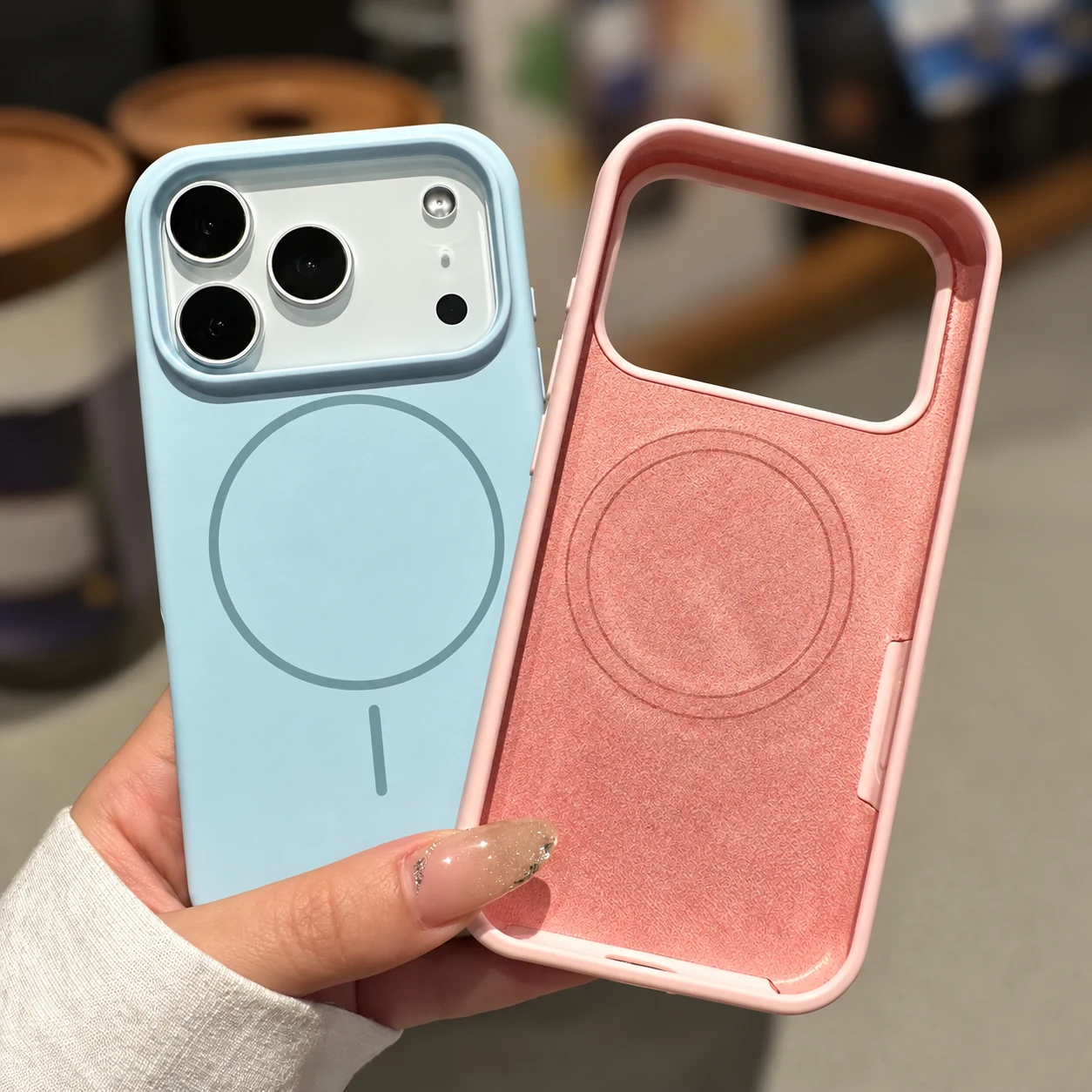 Light blue magnetic silicone case beside a pink case showing its microfiber lining